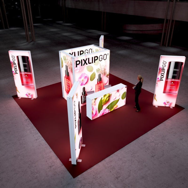 A top-down perspective of the booth, displaying its structure with lighted walls and counters adorned with cosmetic product imagery and floral patterns. A professional figure is seen walking around the setup.